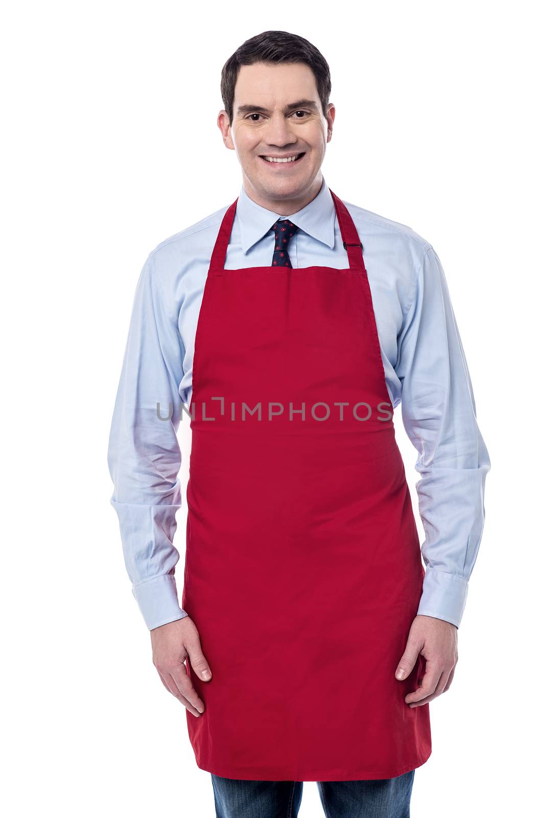 Image of a confident male chef posing over white