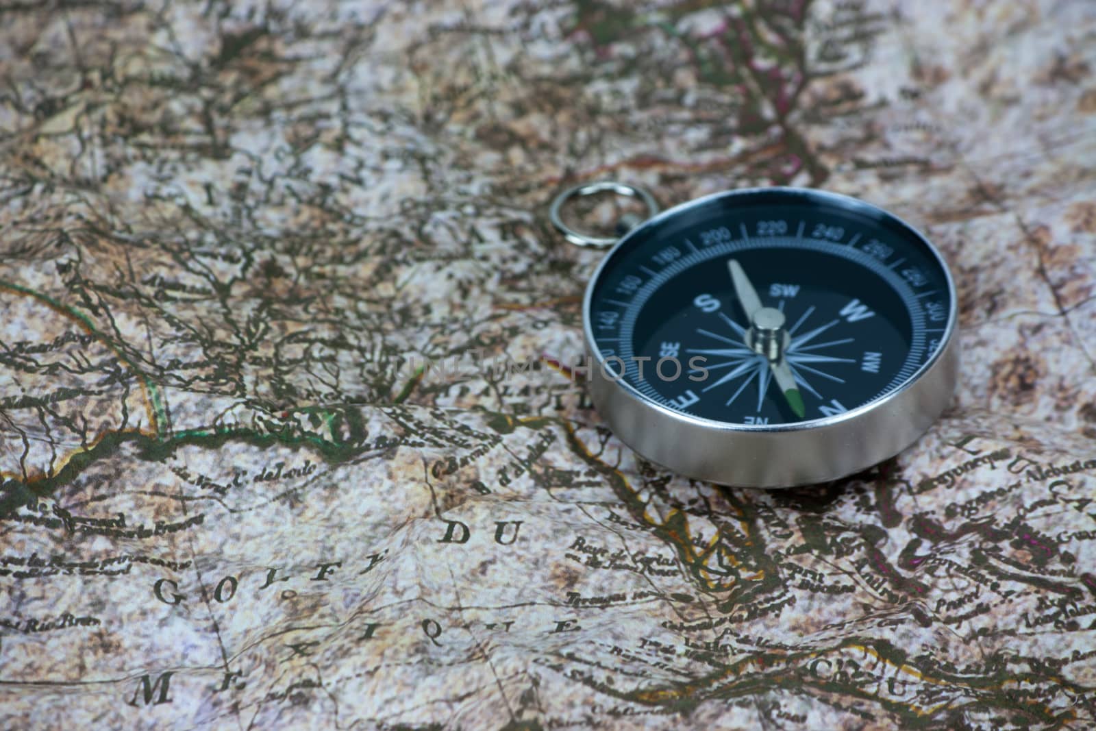 Close up of a compass on an old map