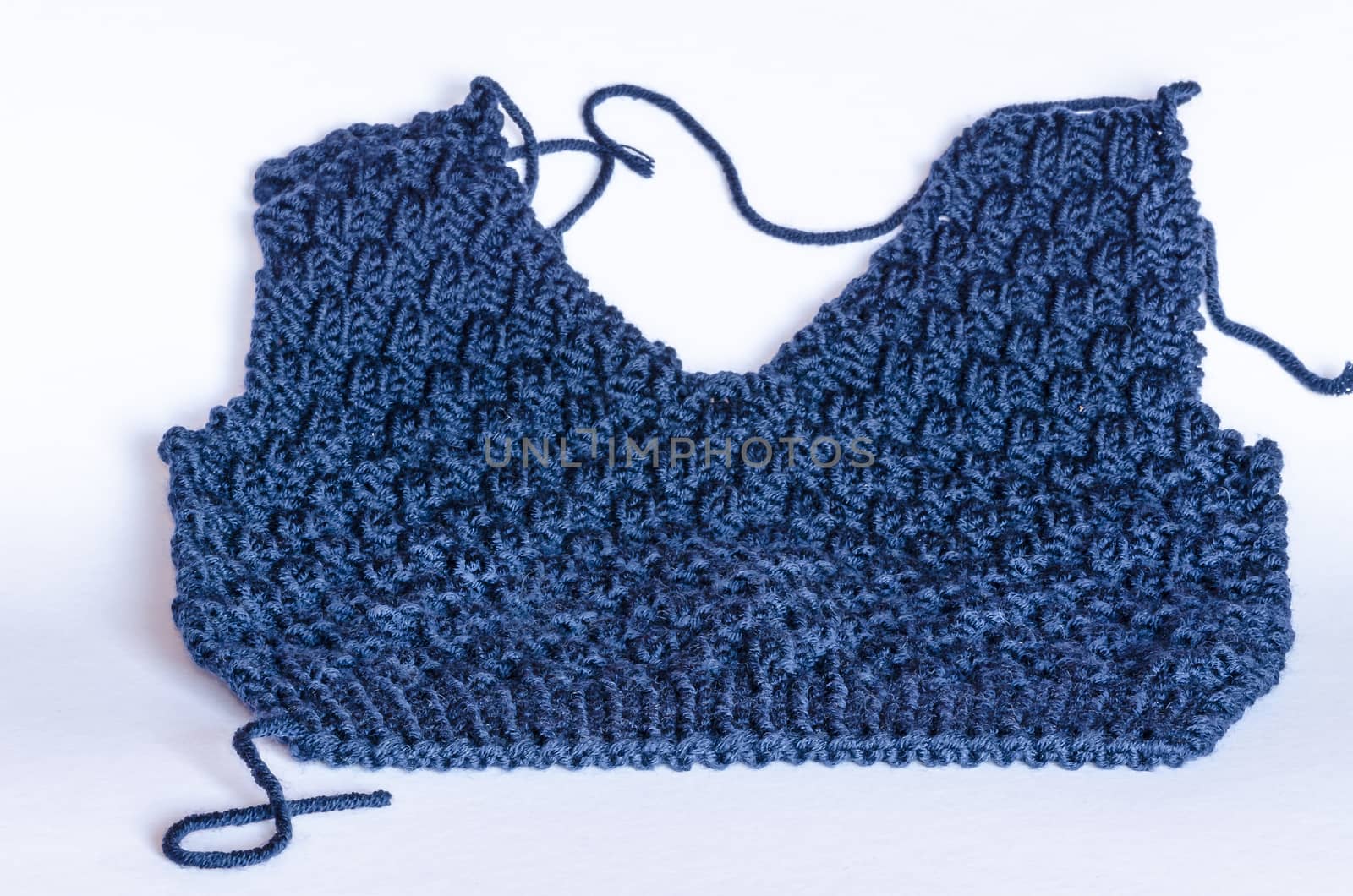 Close up of a blue tank top knitted front on white background.