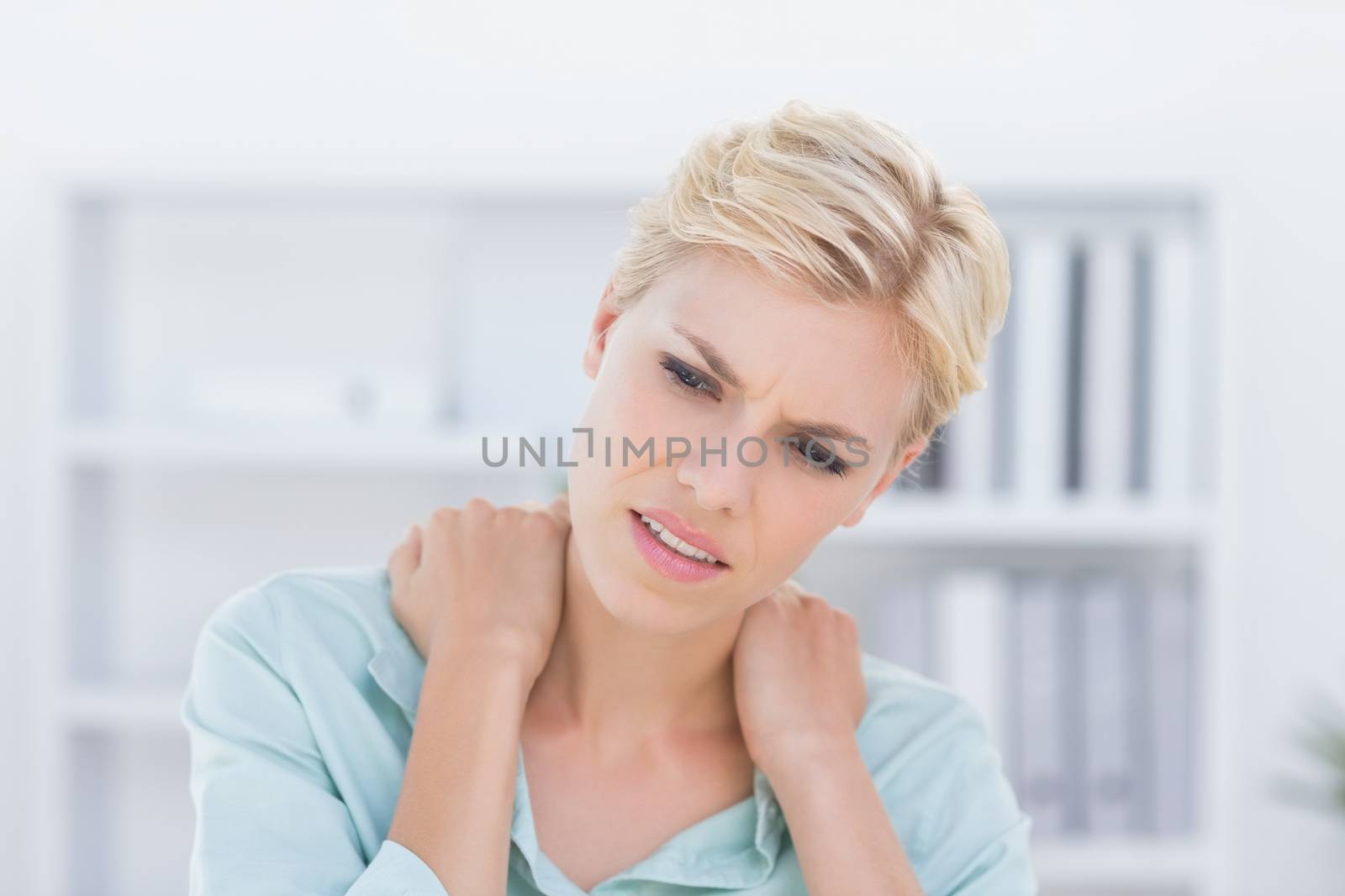 Patient with back pain  by Wavebreakmedia