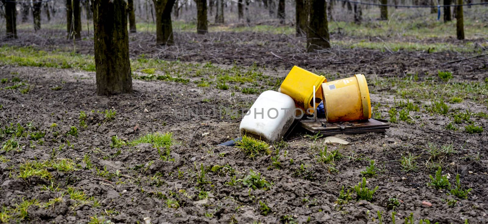 Picture of Three pails on a soil in apple orchard