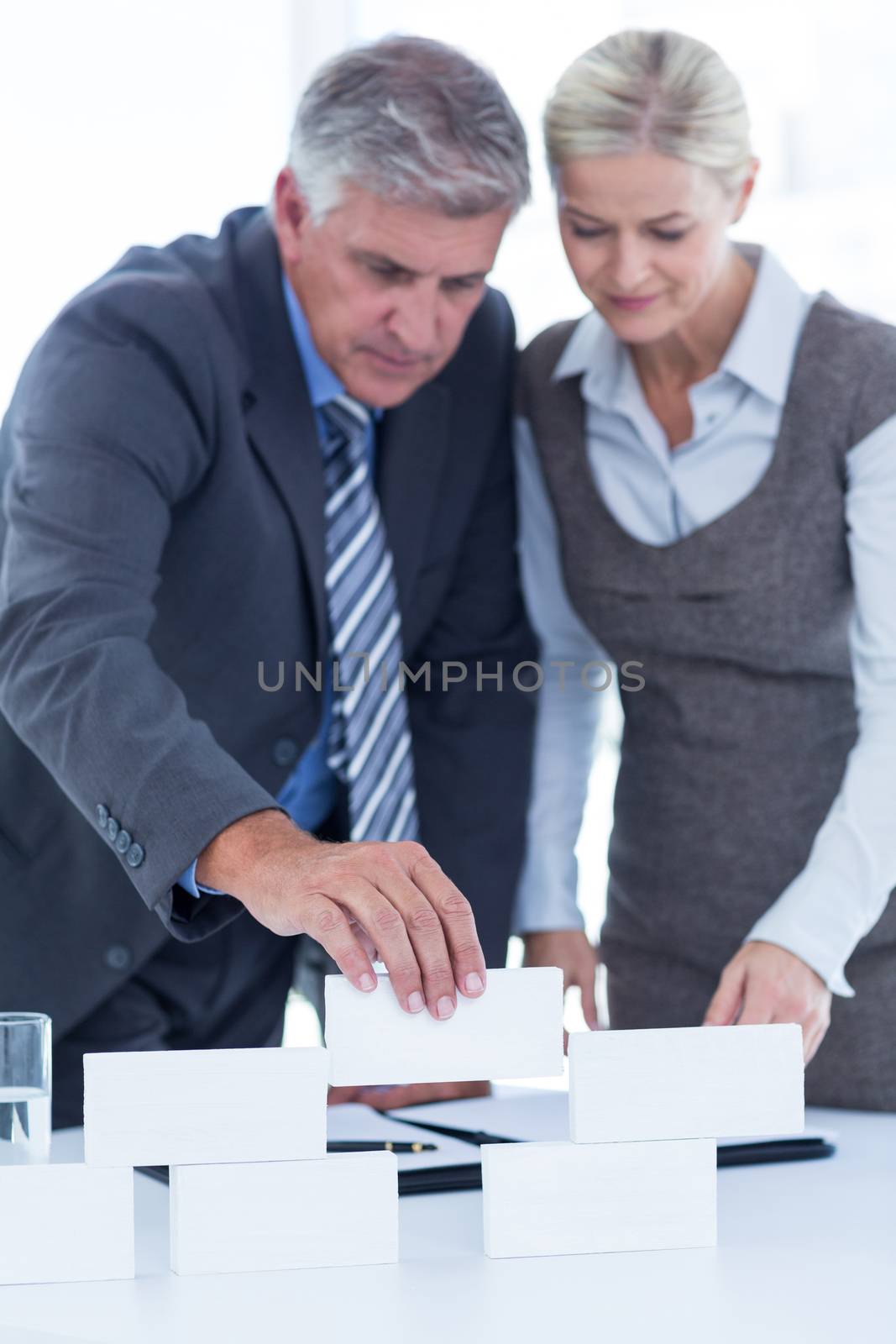 Business people working together and building structure in an office