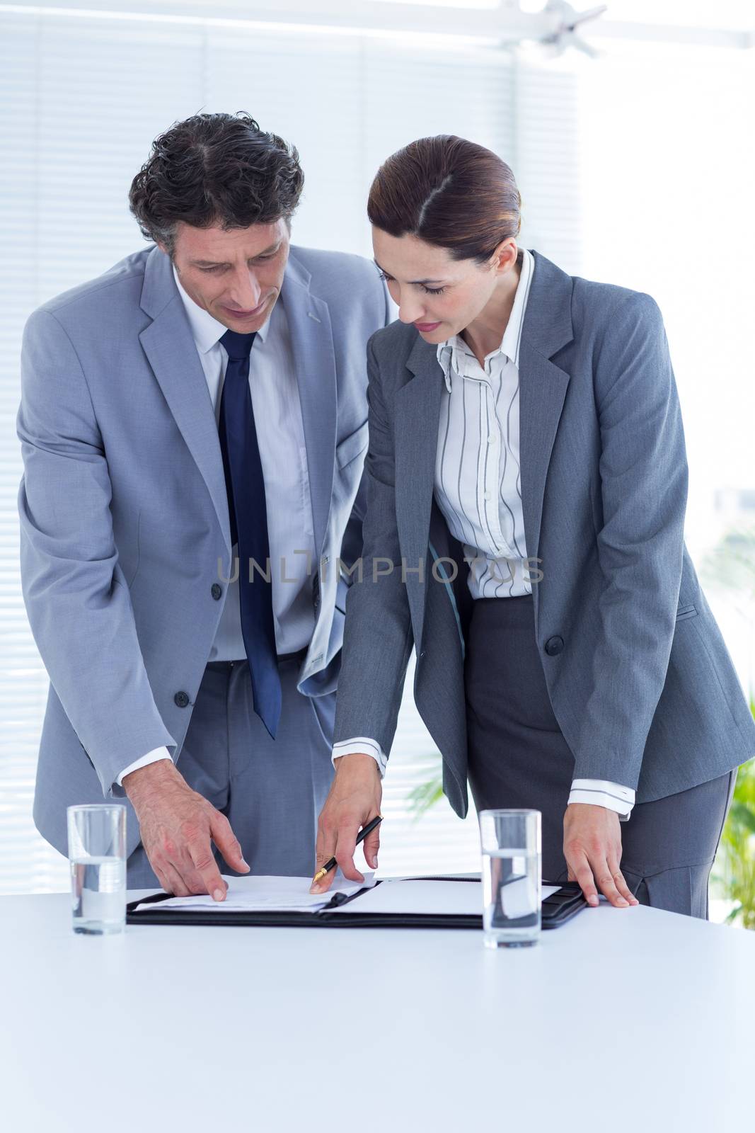 Business people checking file in an office