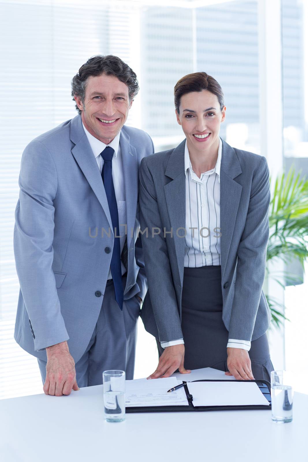 Smiling business people looking at camera in an office