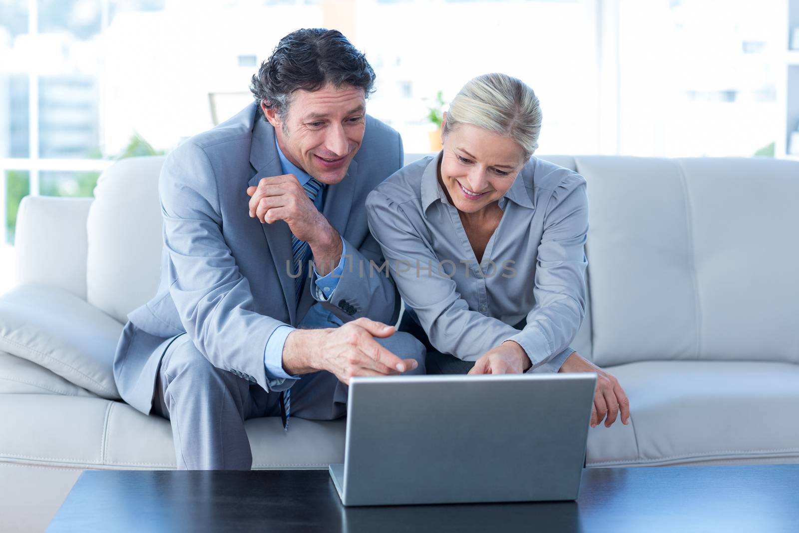 Business people using laptop in the office