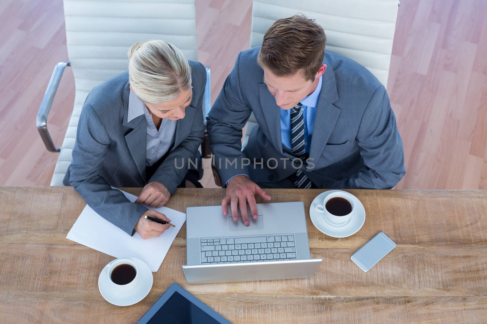 Business people using laptop in the office