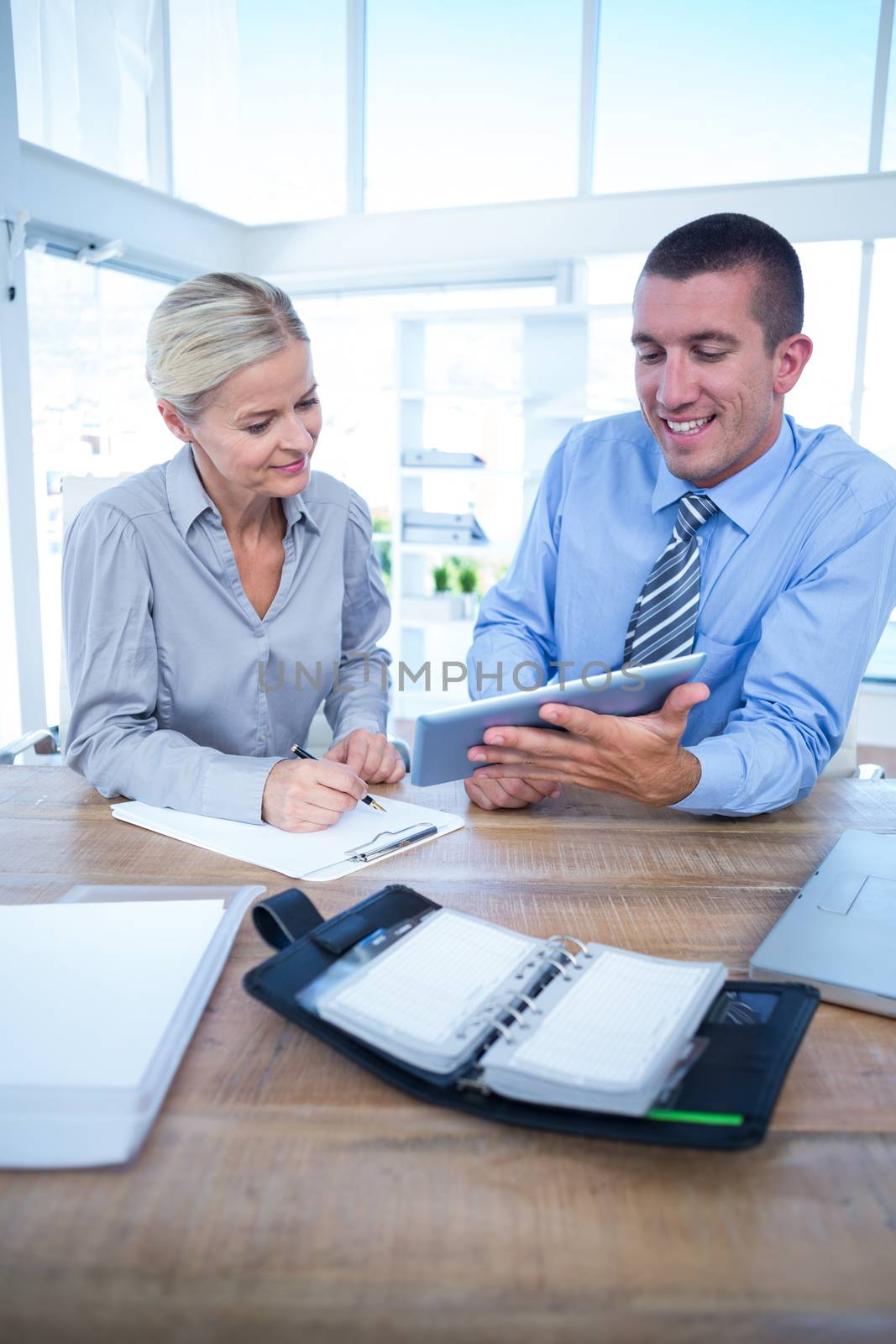 Business people using tablet in office by Wavebreakmedia