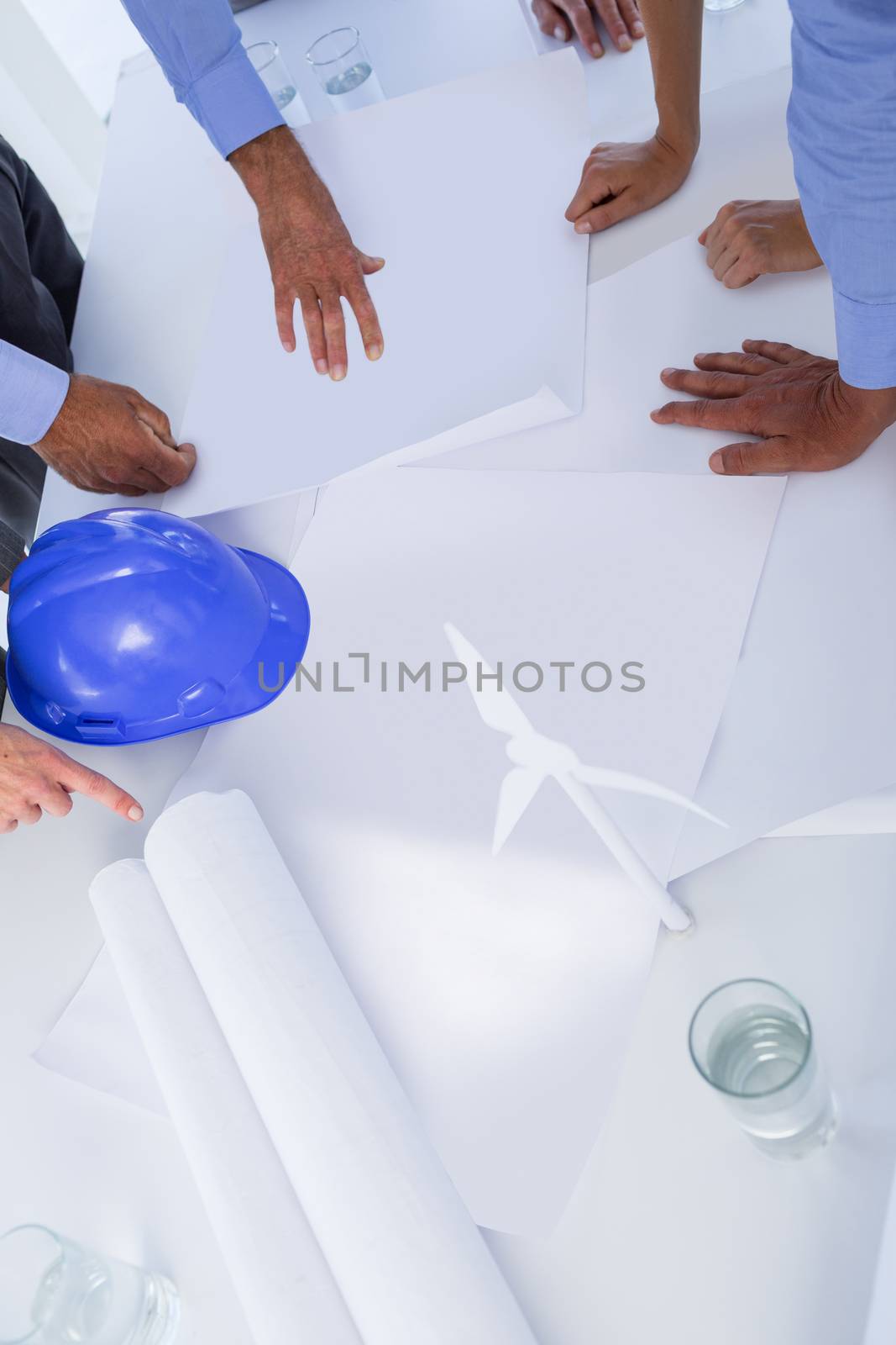 Team of business people looking at construction plan  by Wavebreakmedia