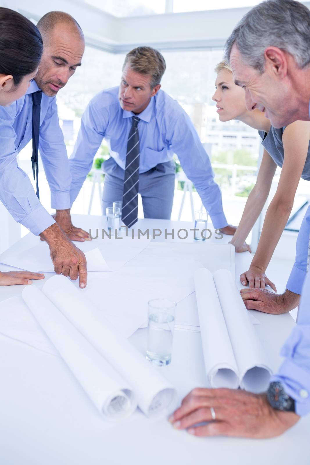 team of business people looking at construction plan in the office