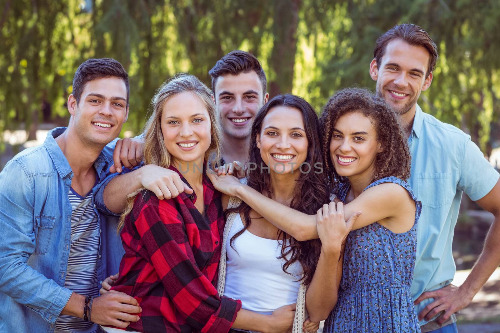 Happy friends in the park by Wavebreakmedia