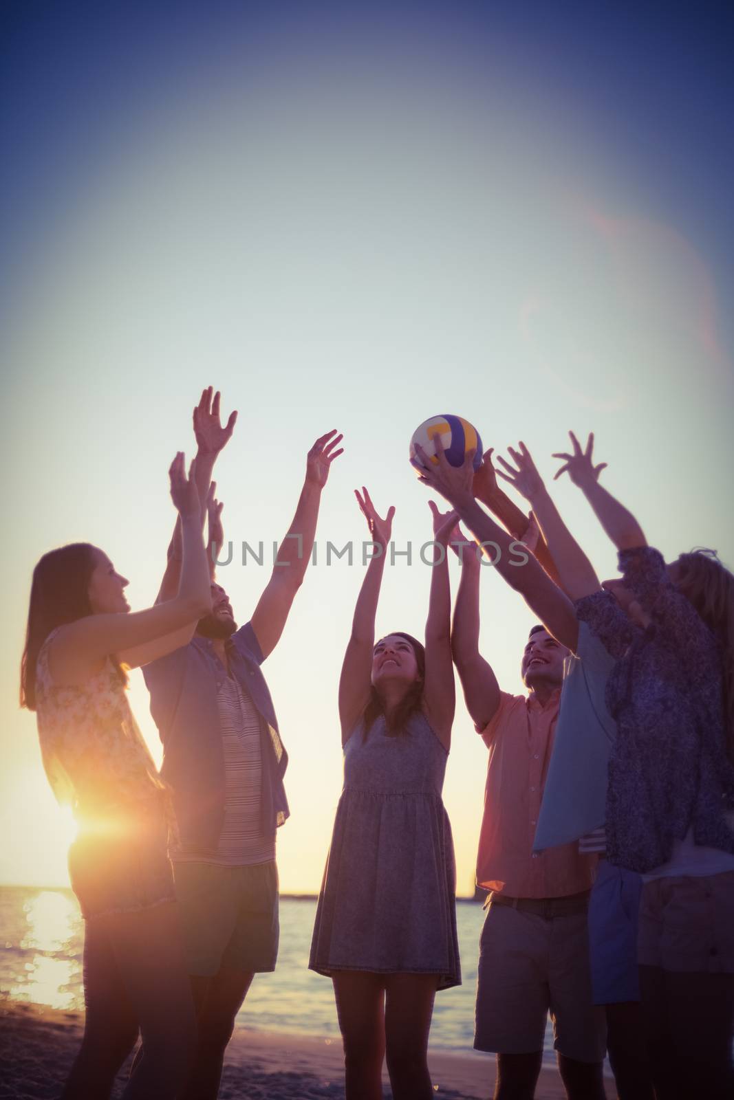 Group of friends playing volleyball  by Wavebreakmedia