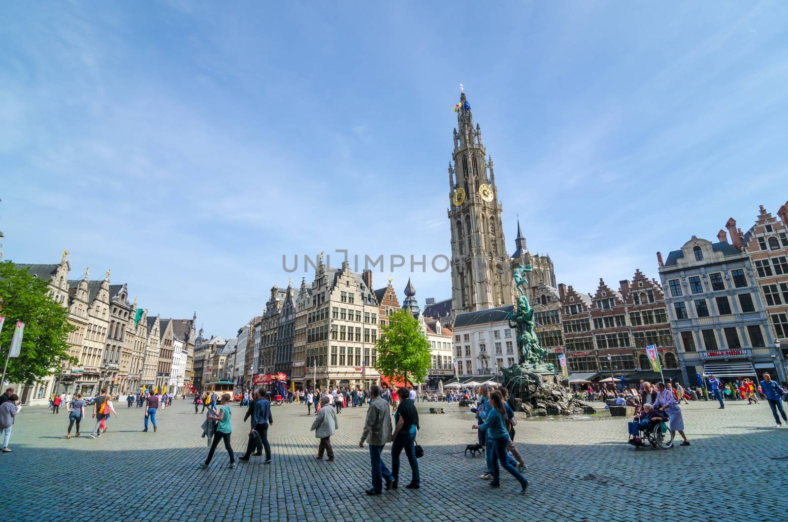 Antwerp, Belgium - May 10, 2015: Tourist visit The Grand Place with the Statue of Brabo, throwing the giant's hand into the Scheldt River and the Cathedral of our Lady. on May 10, 2015 in Antwerp, Belgium. 