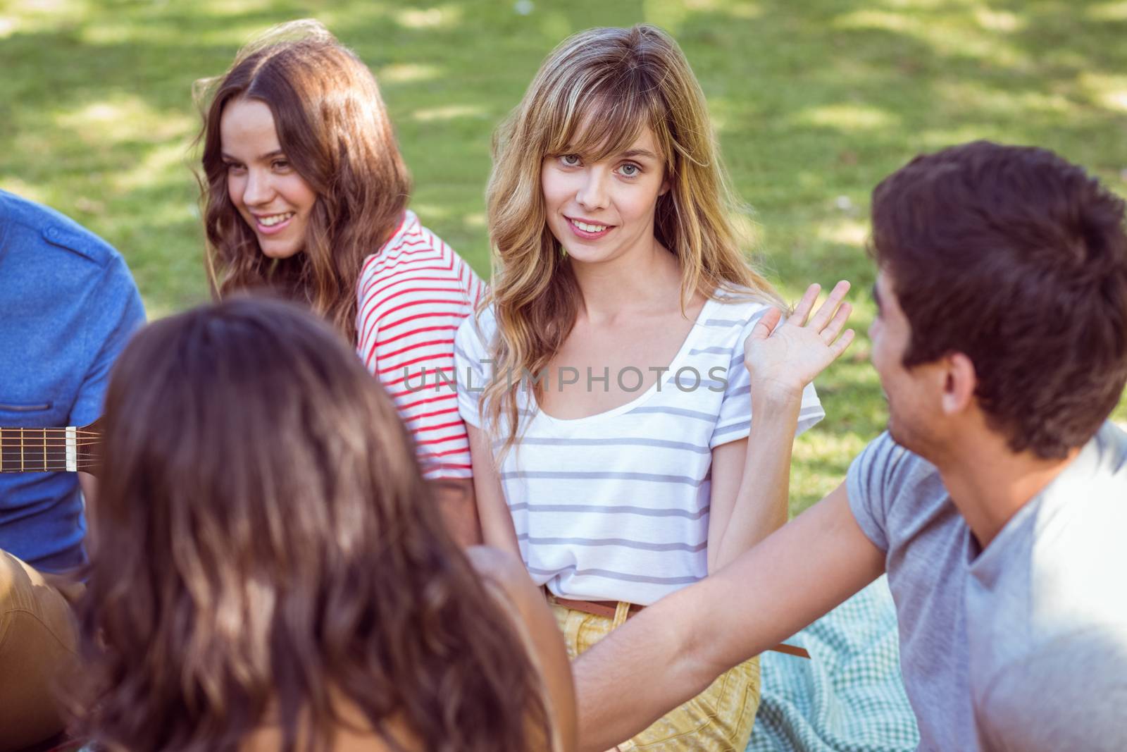 Happy friends in a park  by Wavebreakmedia