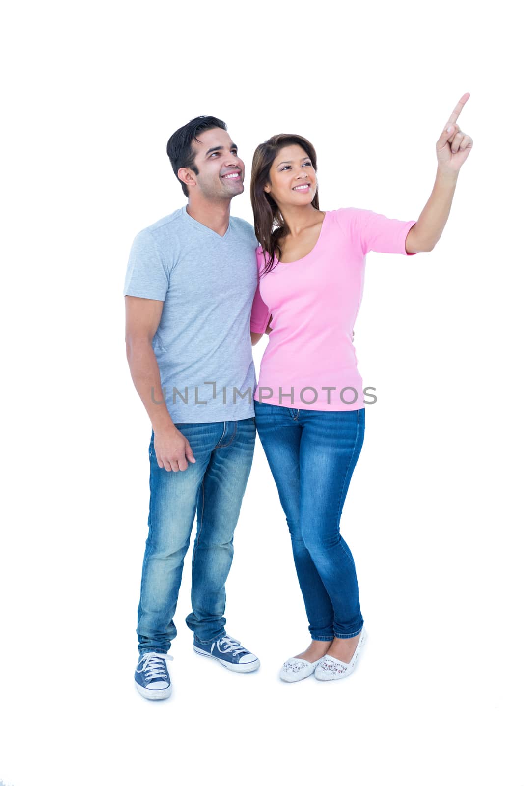 Happy couple standing together and looking away on white background