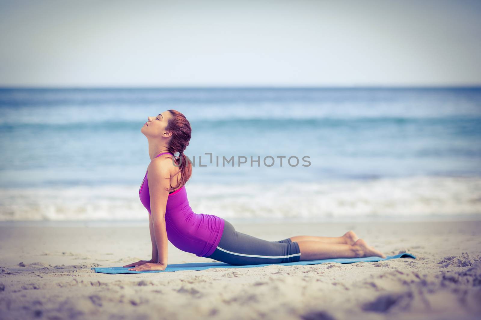 Brunette doing yoga on exercise mat by Wavebreakmedia
