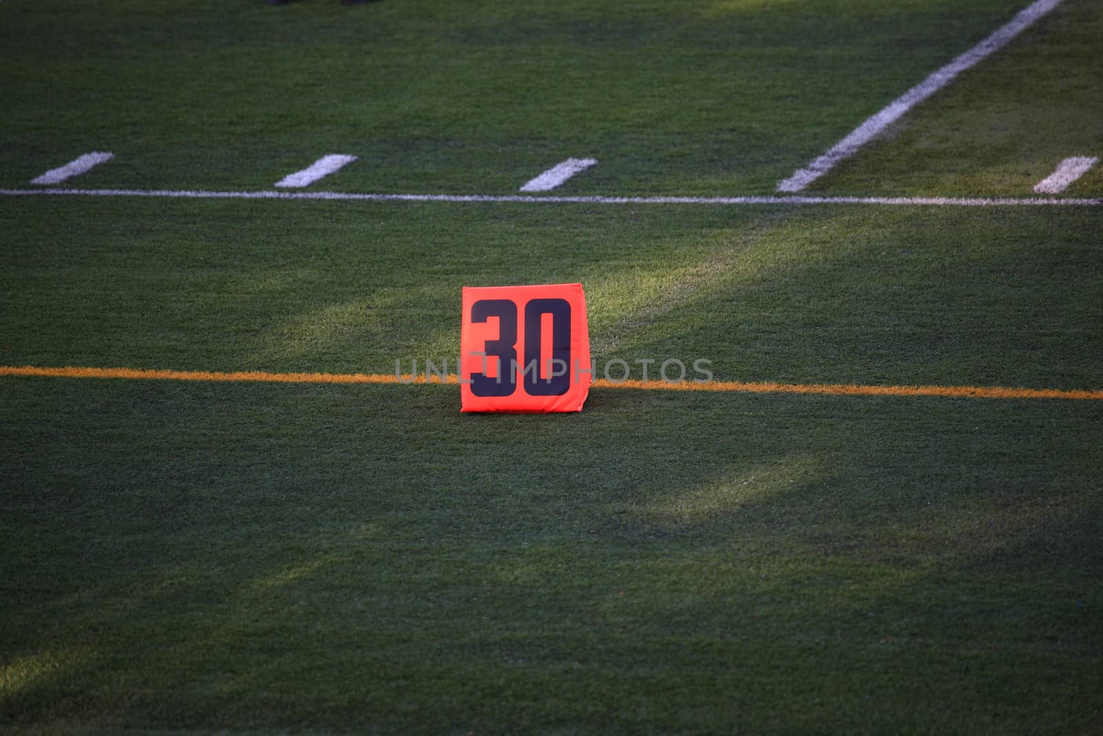 Football game 30 Yard Marker on a green turf field.