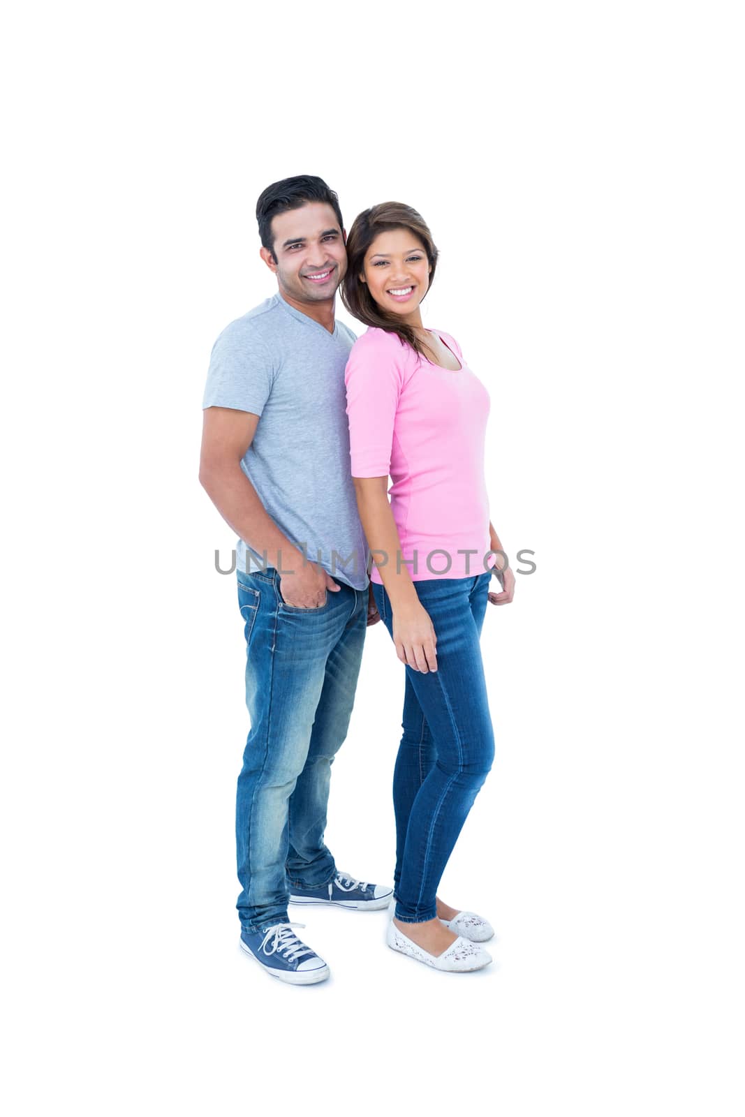 Happy couple standing together and looking at camera on white background