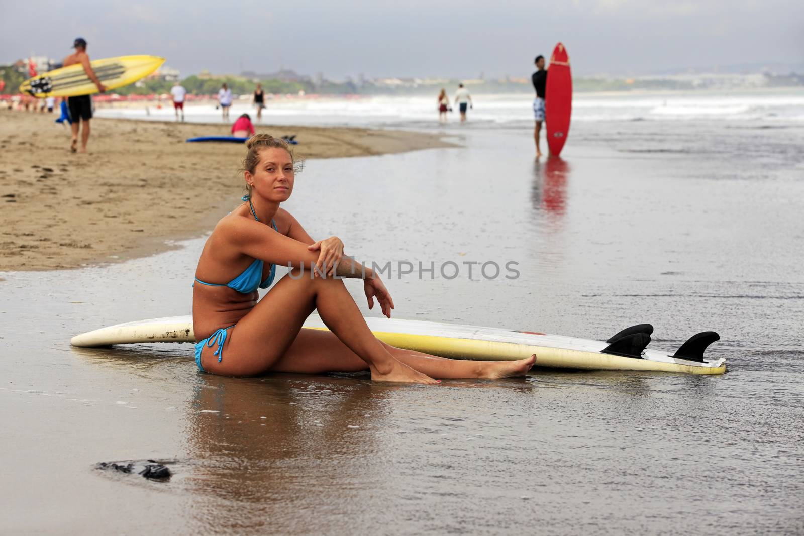 Surfer girl resting on the ocean