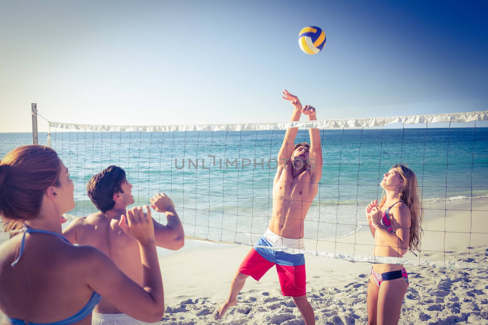 Friends playing volleyball  by Wavebreakmedia