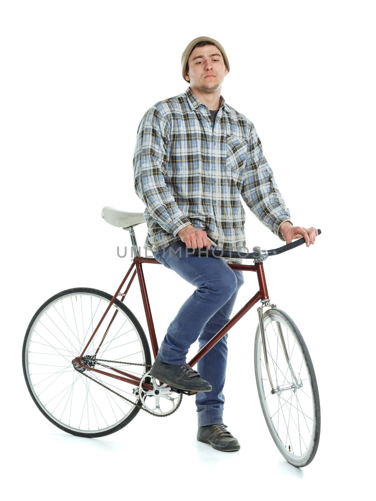 Young man doing tricks on fixed gear bicycle on a white background