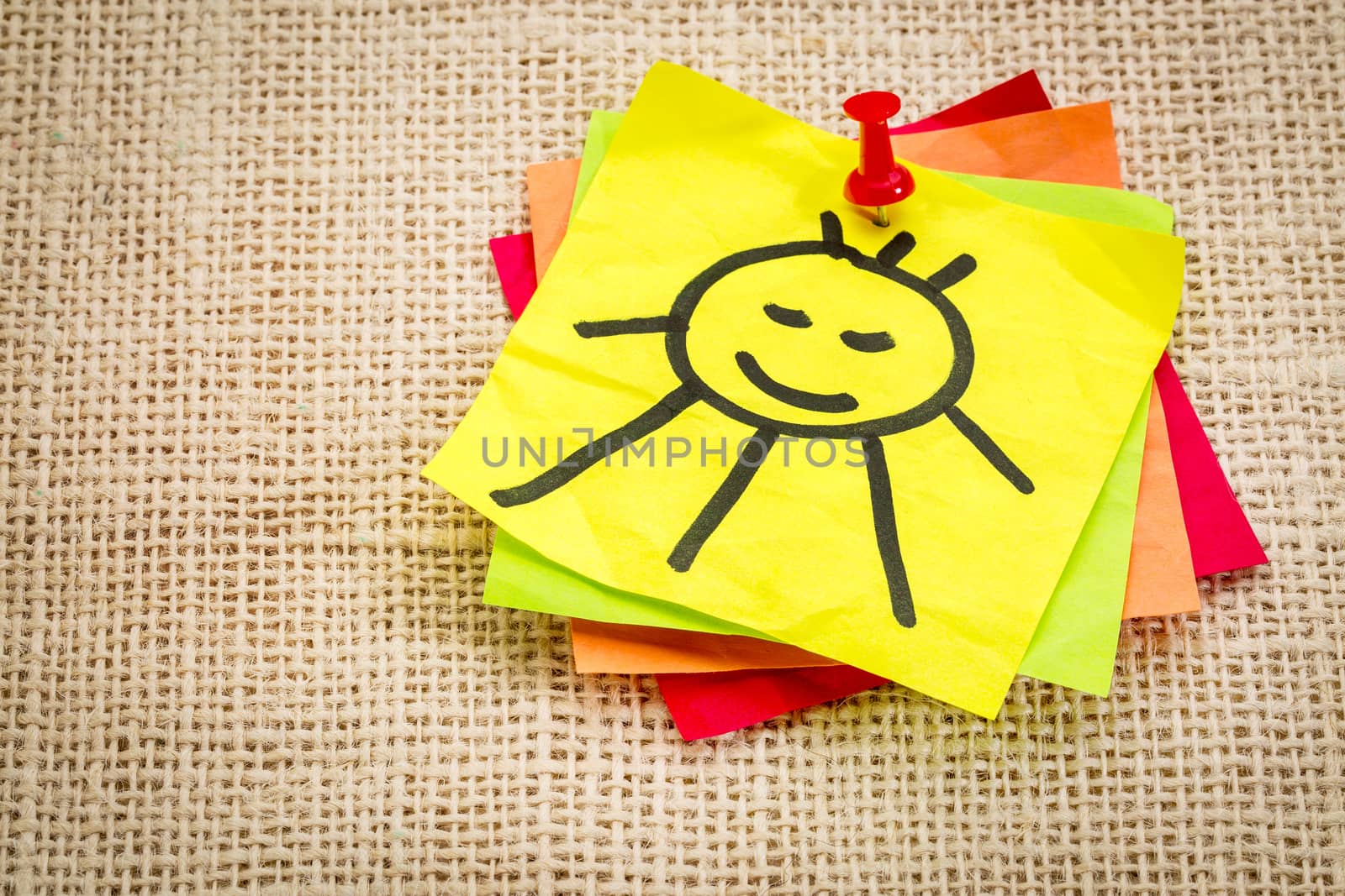 smiling sun on sticky note - reminder to smile and be positive
