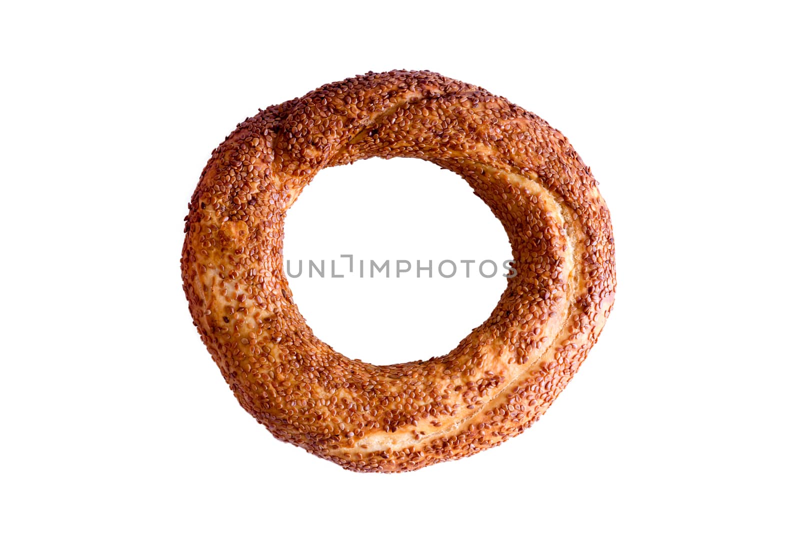 Freshly baked crispy golden Turkish simit, a traditional circular bread with sesame seeds served with Turkish tea, isolated on white