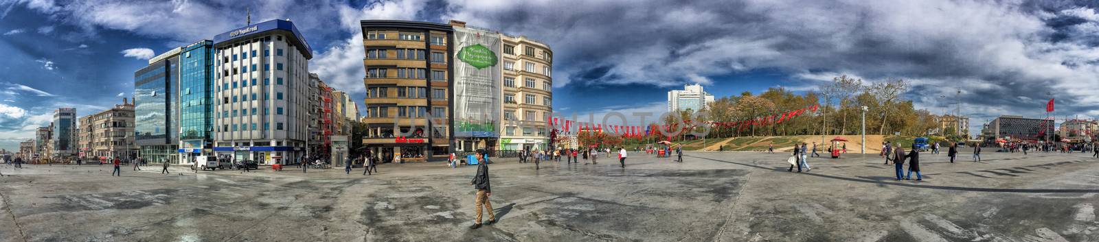 ISTANBUL, TURKEY - OCTOBER 23, 2014: People walking at Taksim Square in Istanbul. Taksim Square is a leisure district famous for its restaurants, shops, and hotels.