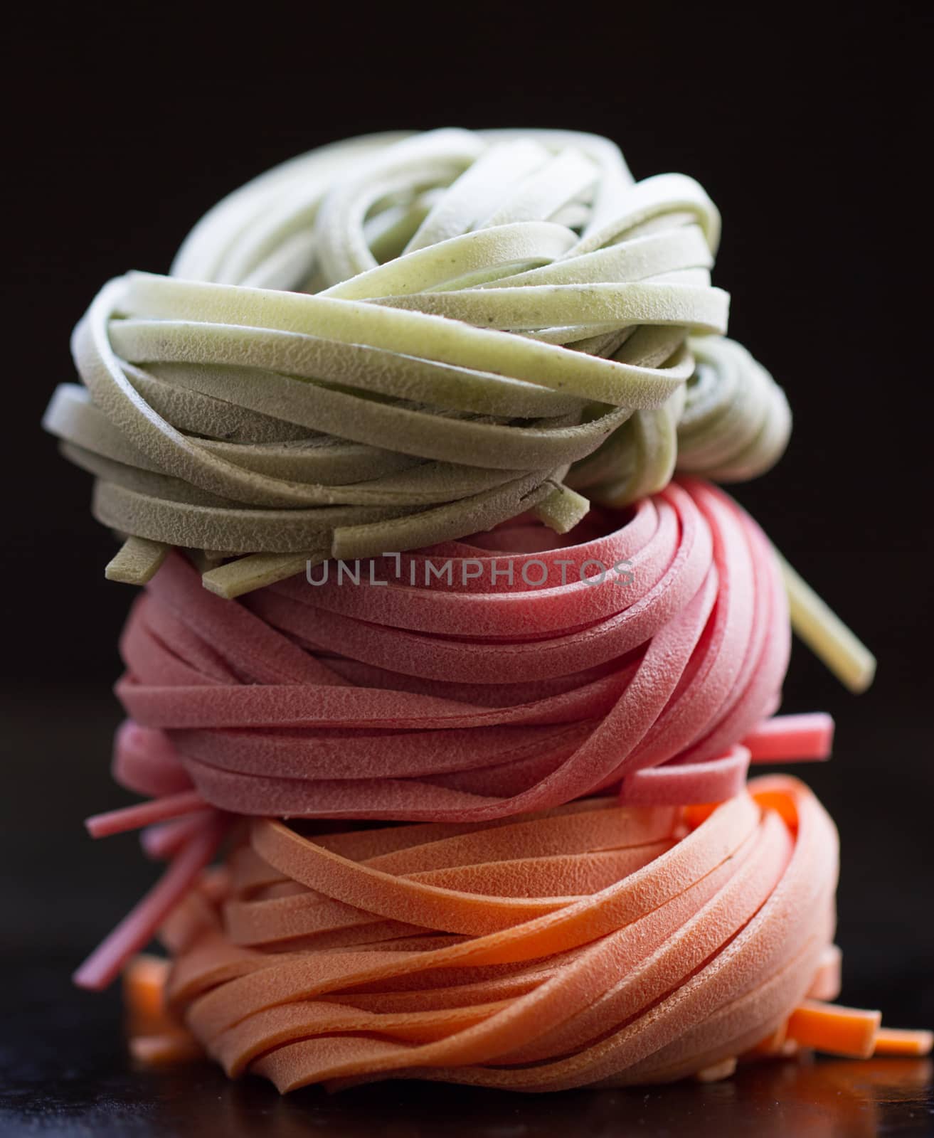 colorful pasta tagliatelle on a black background