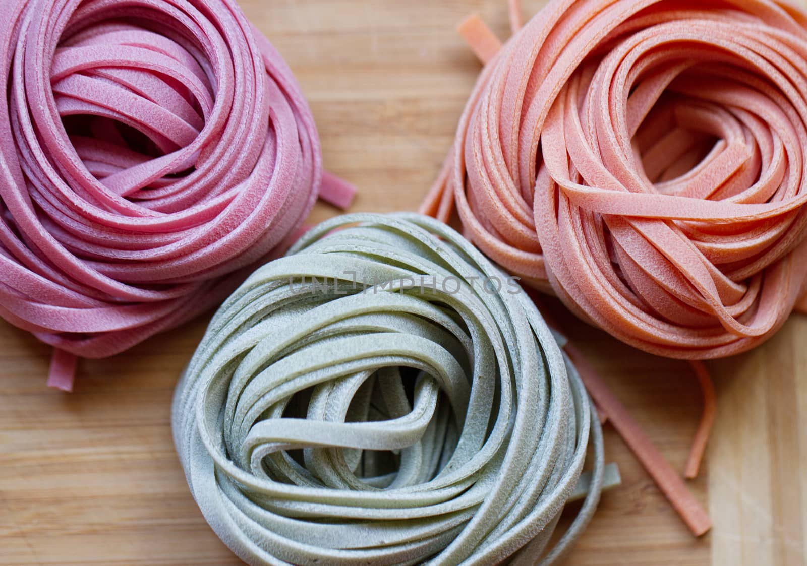 colorful pasta tagliatelle on a wooden table