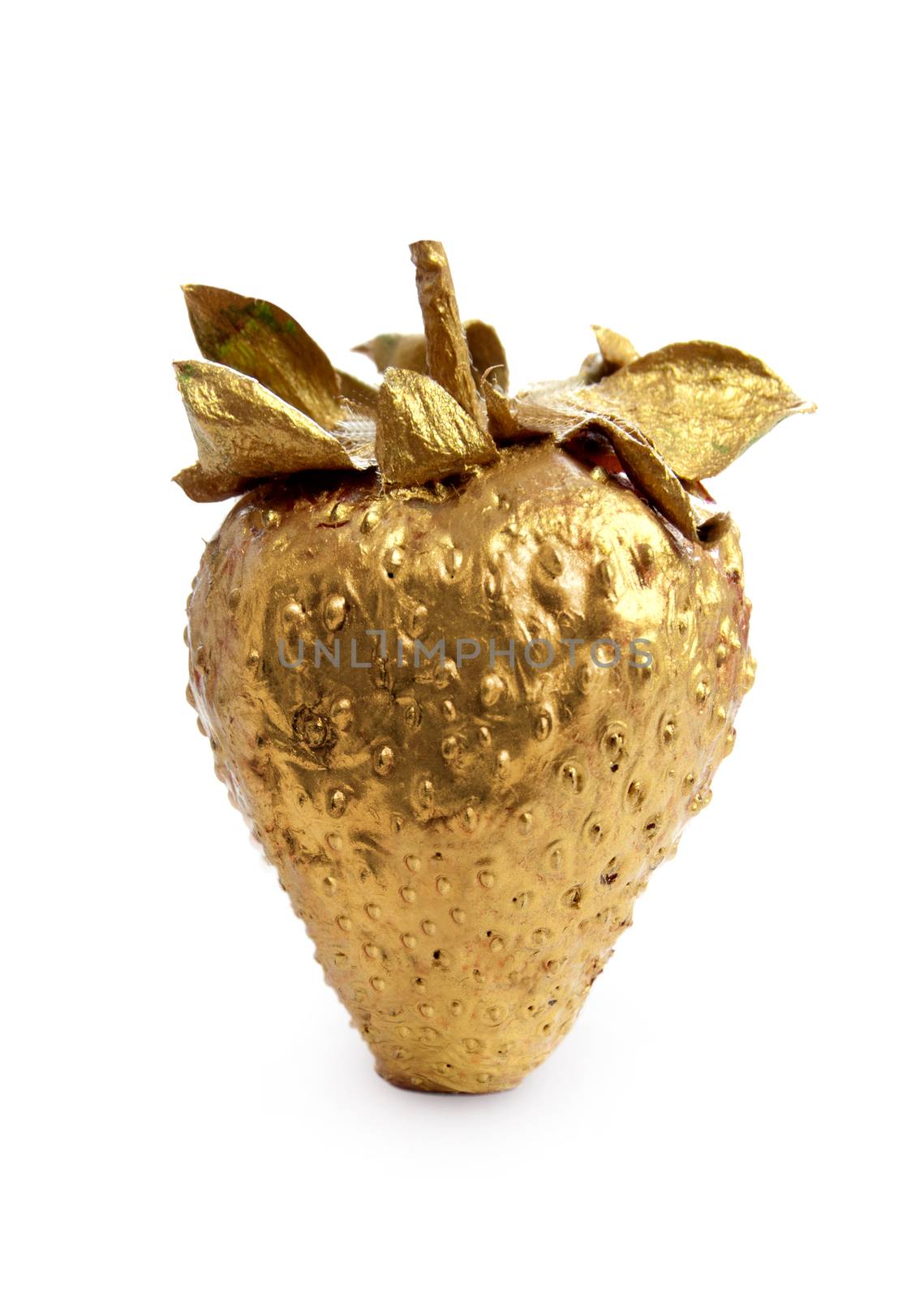 Gold strawberry over a white background