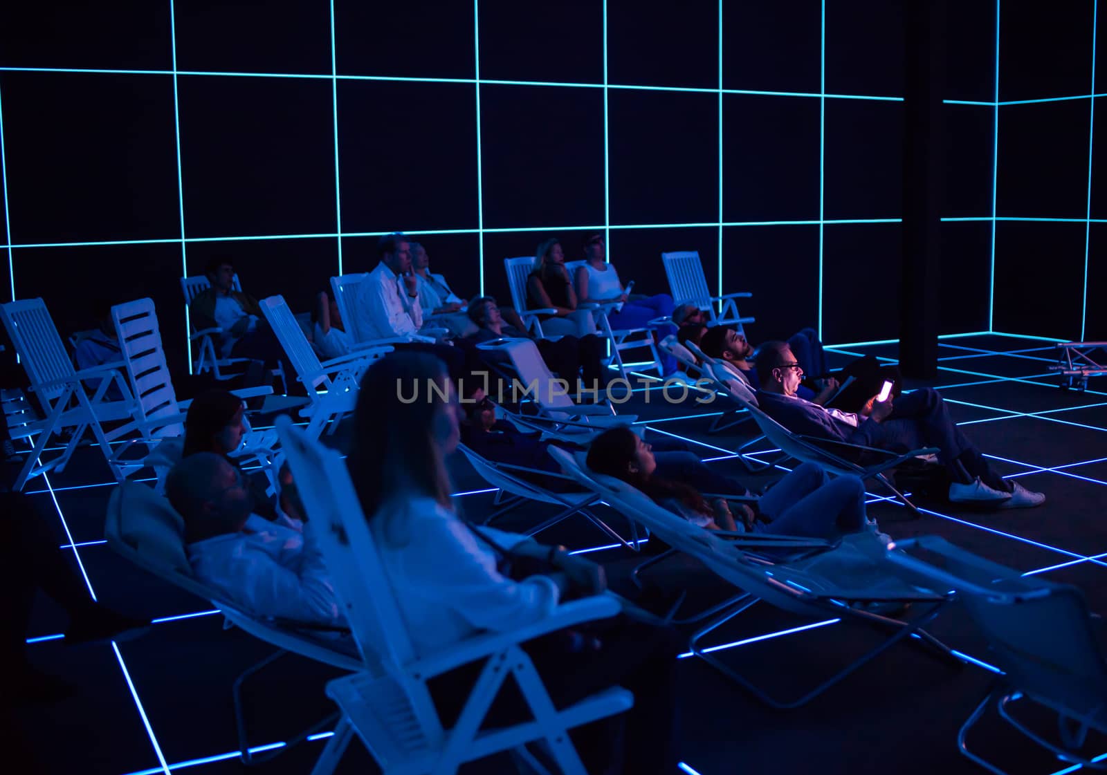 VENICE, ITALY - MAY 06: People looking "Factory of the Sun" video installation by Hito Steyerl at German pavilion during the 56th Venice Biennale on May 06, 2015