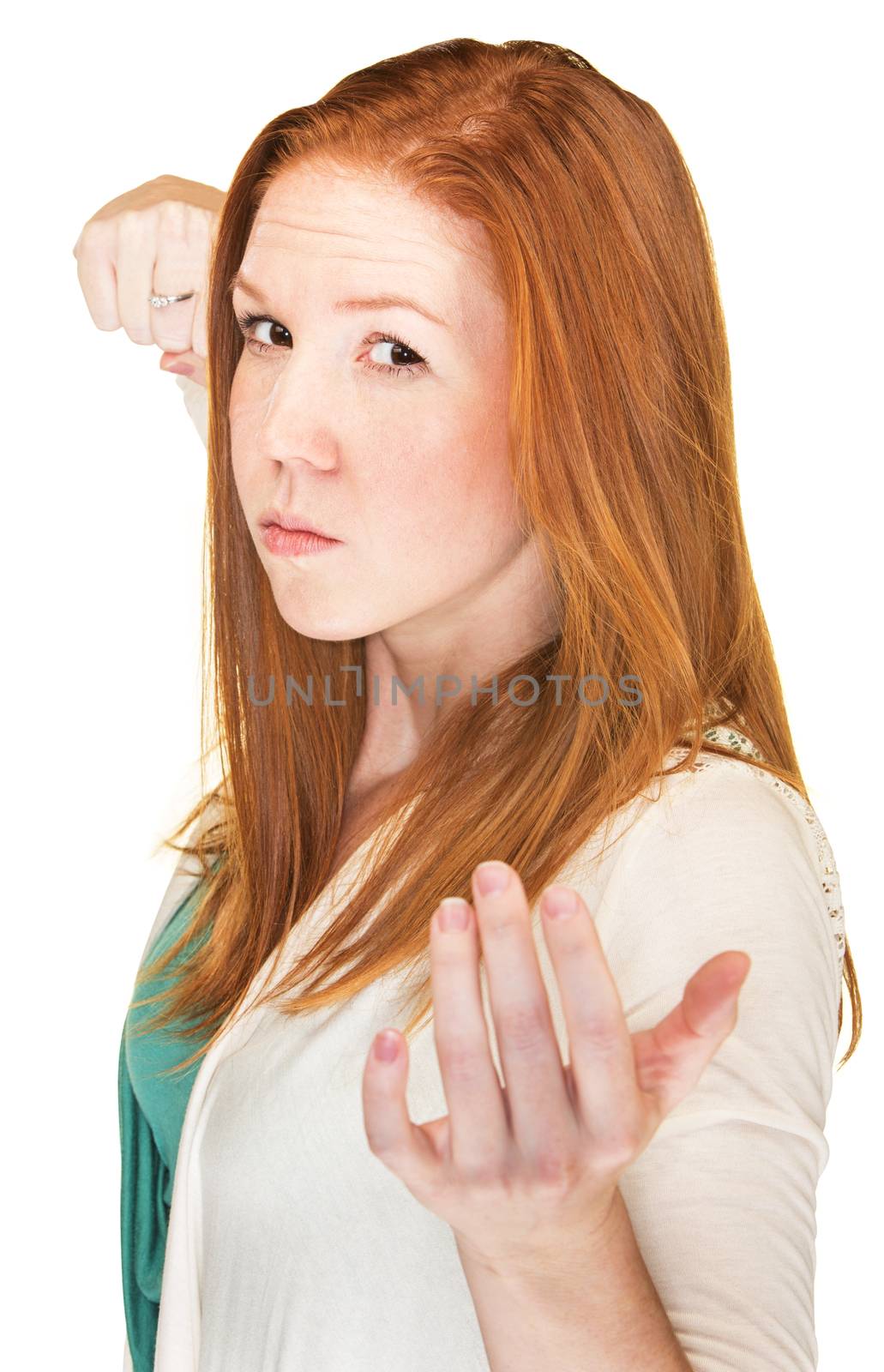 Isolated woman with threatening expression and clenched fist