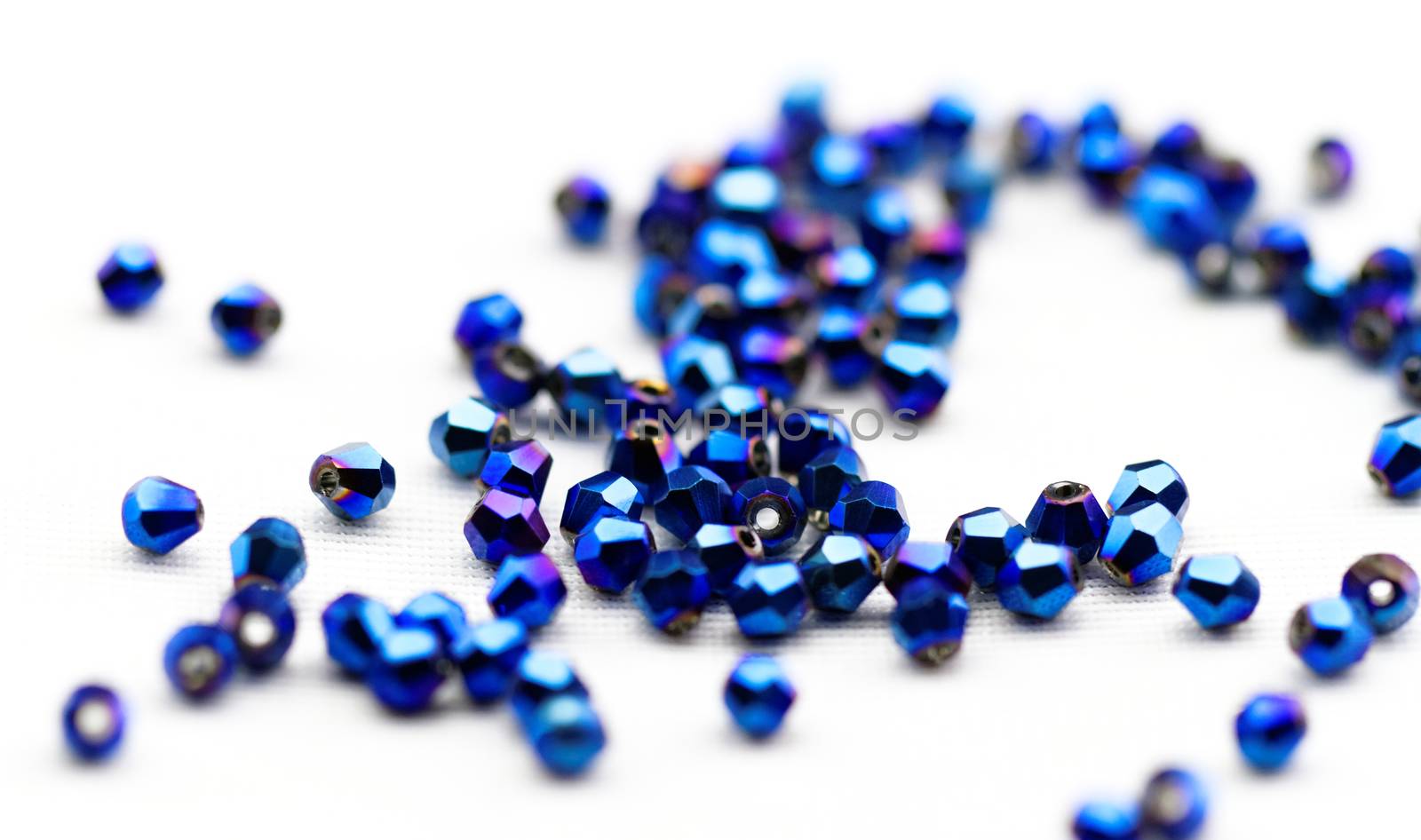 Beautiful glass beads closeup on white background