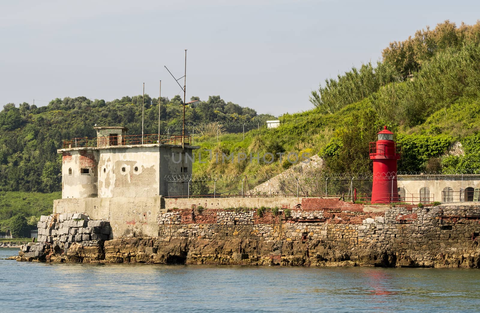 Little lighthouse on a small rocky island in mediterranean sea