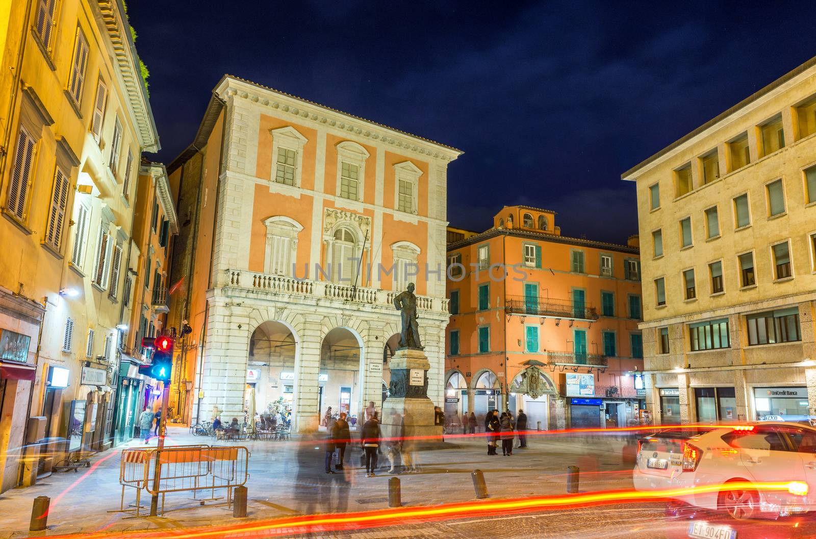 PISA, ITALY - MAY 24, 2014: Tourists in Garibaldi Square at night. The city attracts 3 million people annually.