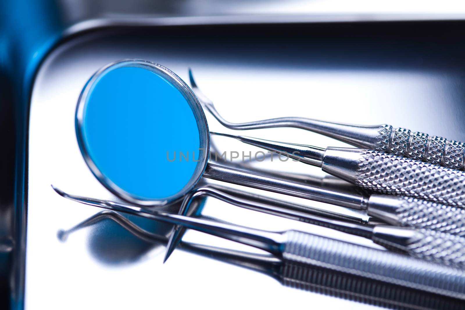 Dentist equipment on blue background by JanPietruszka