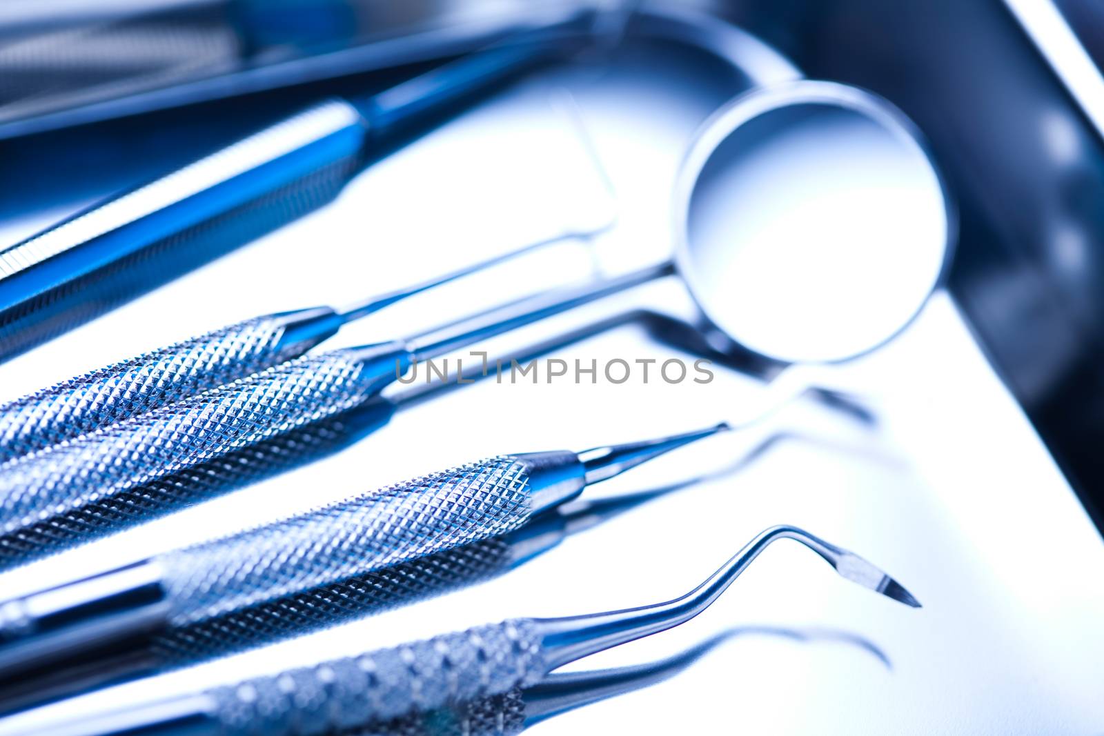 Dentist equipment on blue background by JanPietruszka