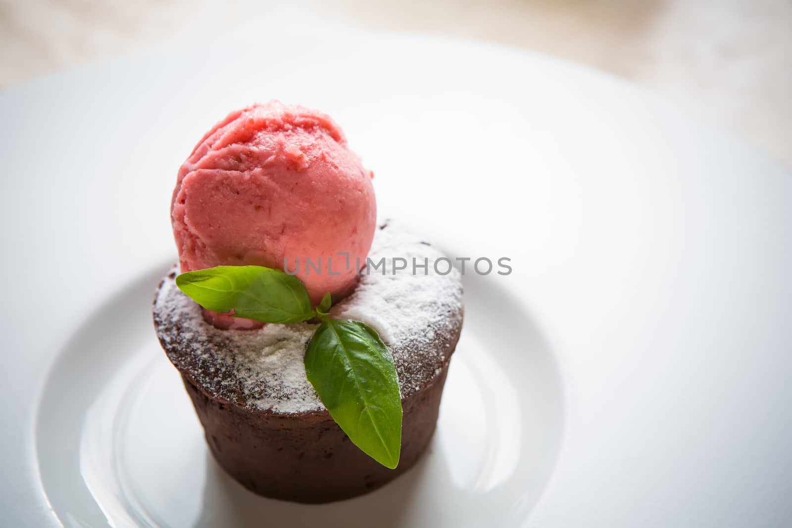 Warm dessert chocolate cake Fondant served on plate with ice-cream ball