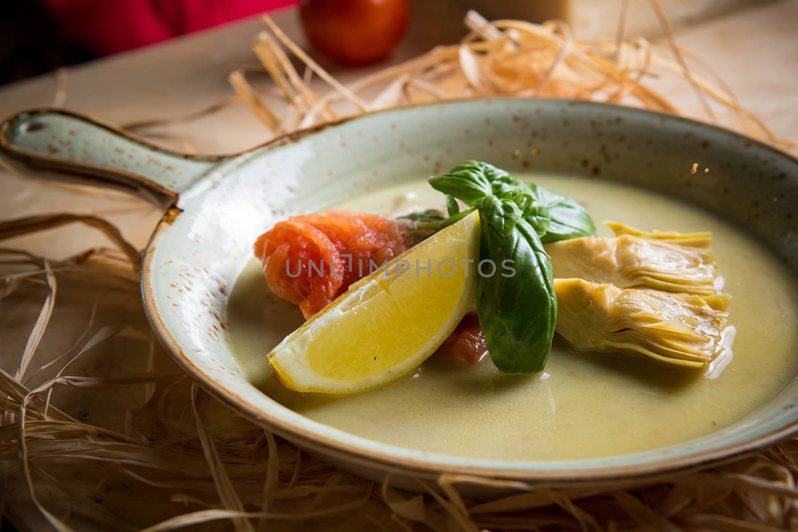 Fish fillet with artichokes and tomatoes with lemon