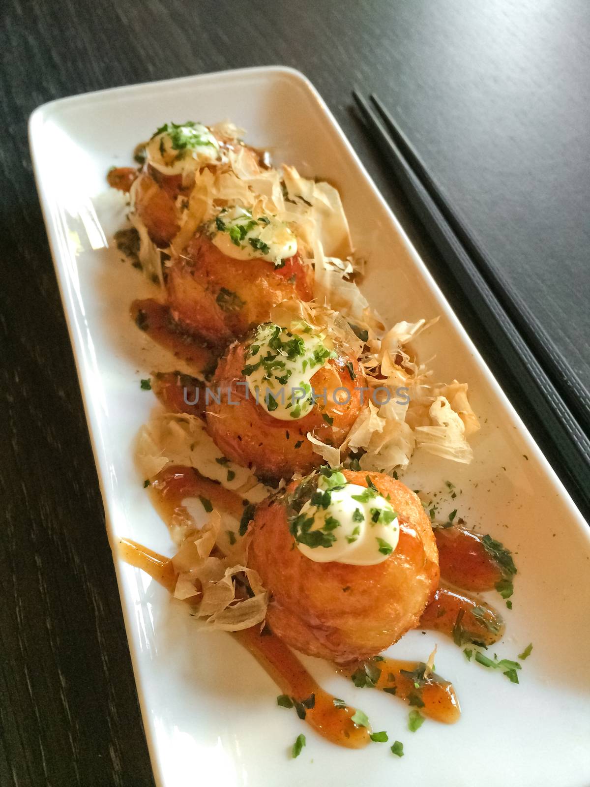 Japanese tapas, traditional cuisine. Takoyaki, creamy octopus balls.