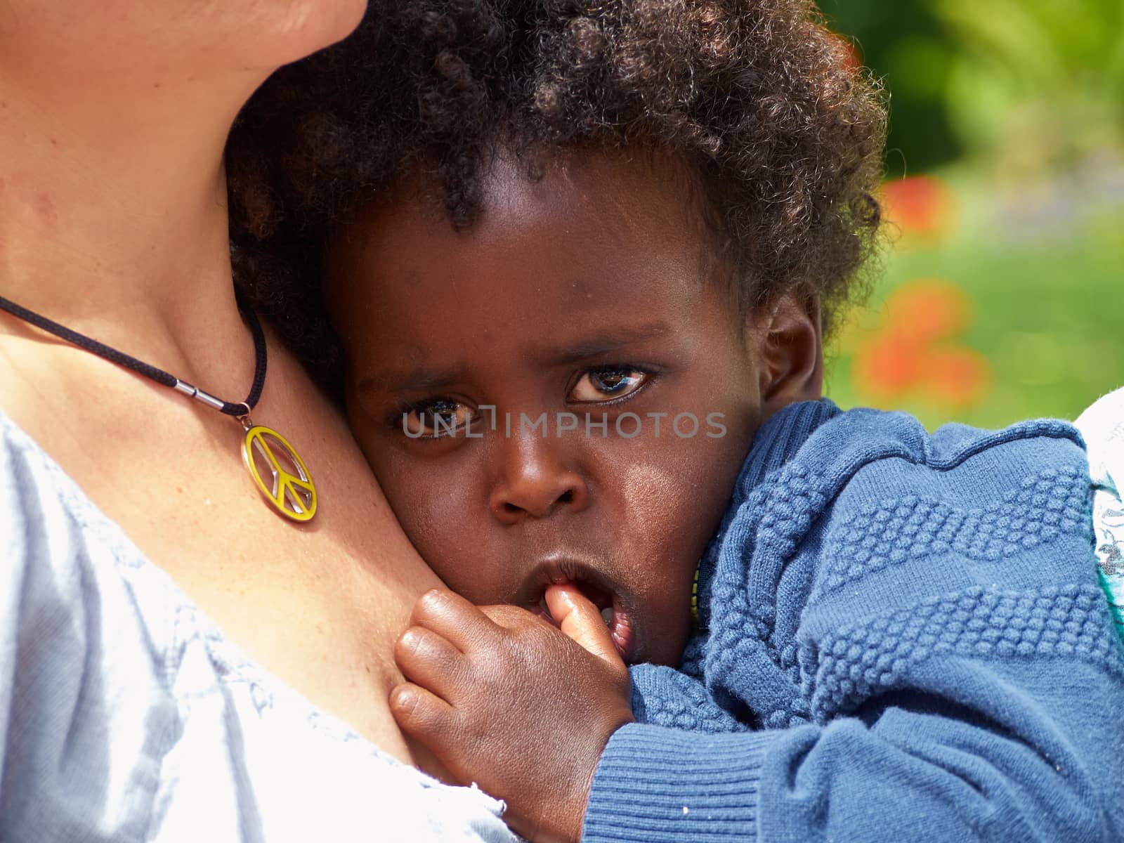 Adorable black sad baby crying with bad mood