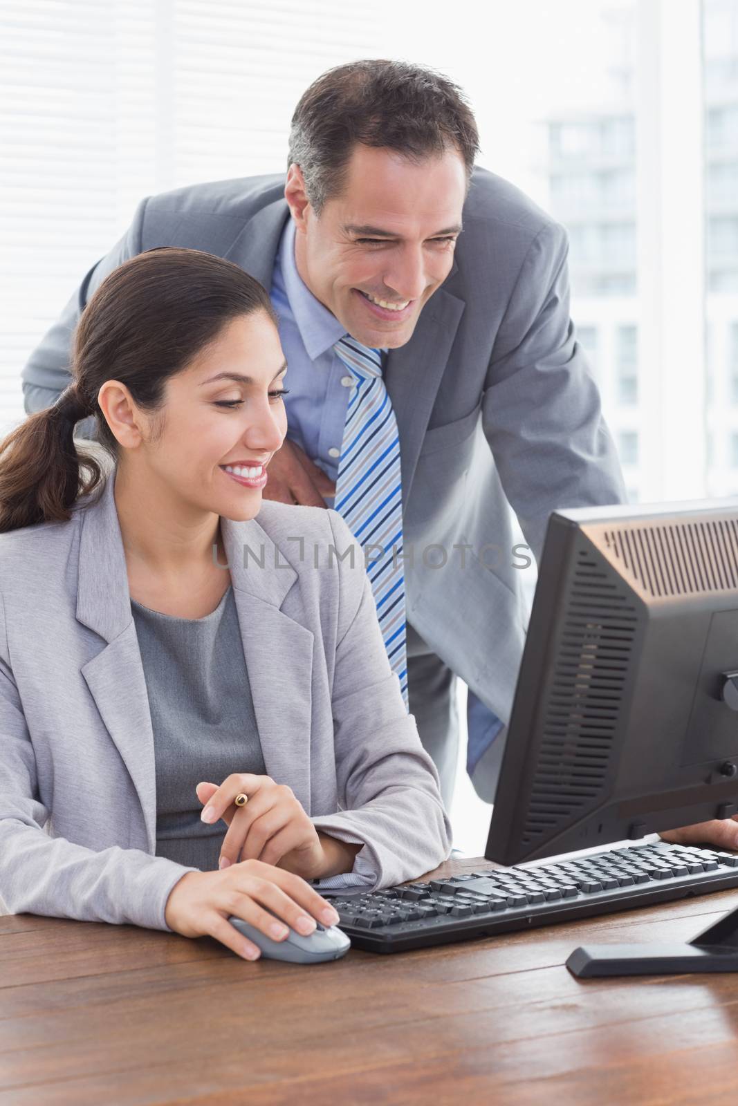 Smiling business partners working together in an office