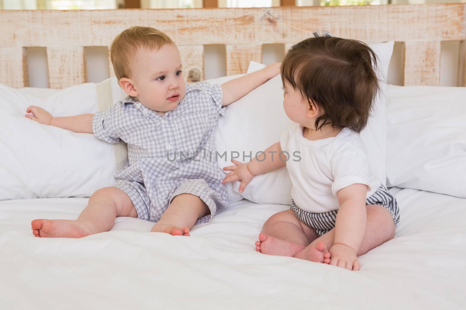 Very beautiful cute babies boy and girl at home in bedroom