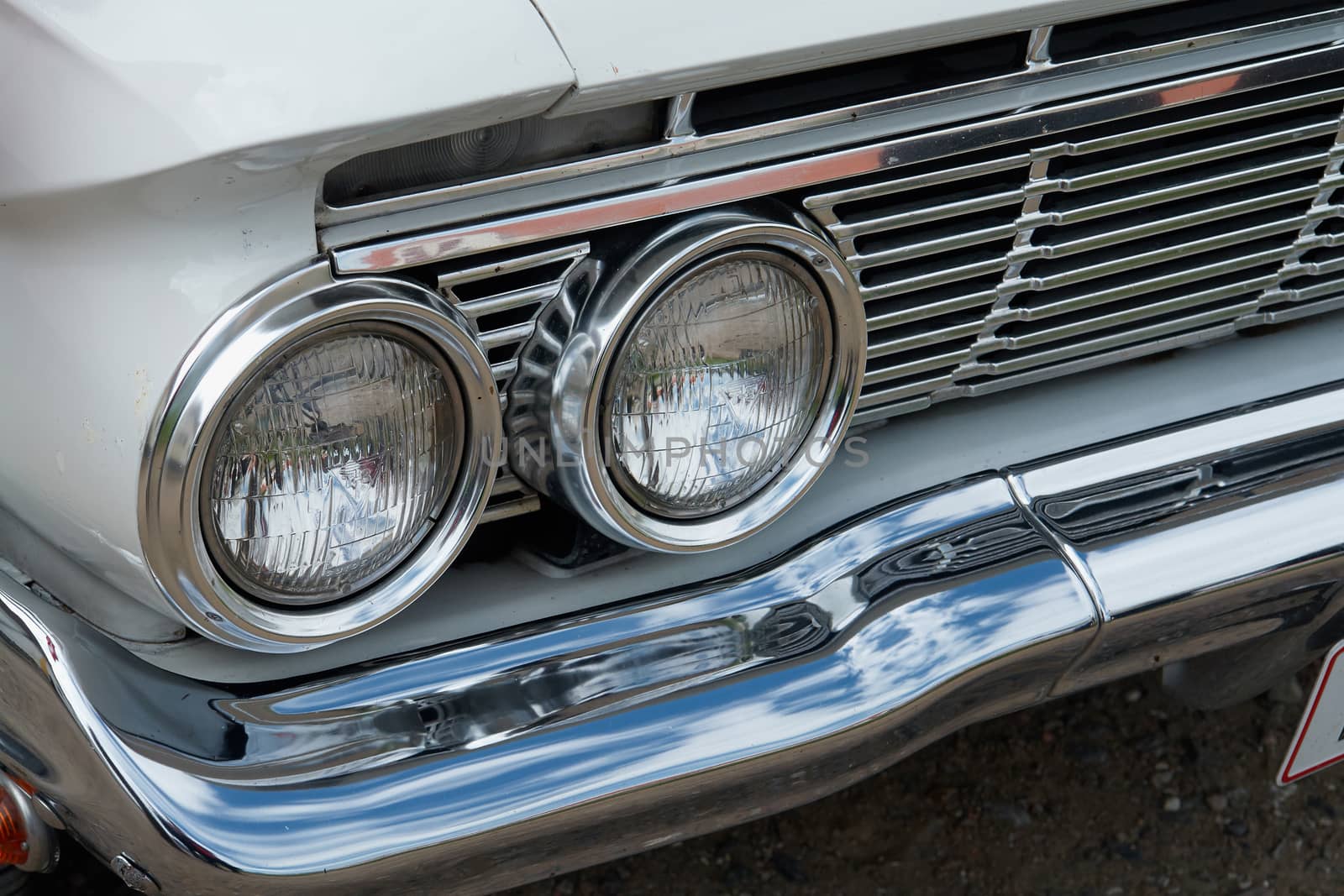 Detalis of headlight of a vintage car in an antiques show                               