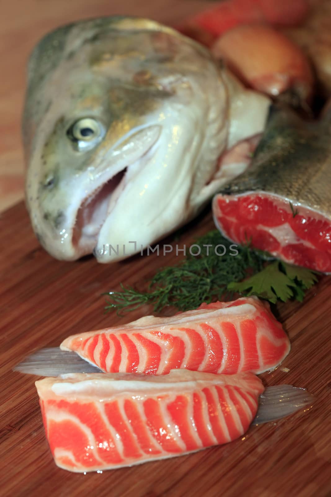 Fresh red salmon fish on wooden cooking desk