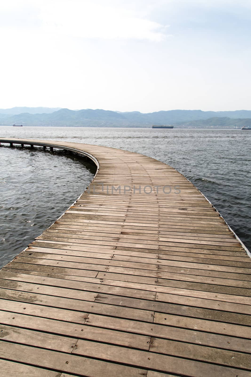 Close up front view of wooden path, bridge inside sea.