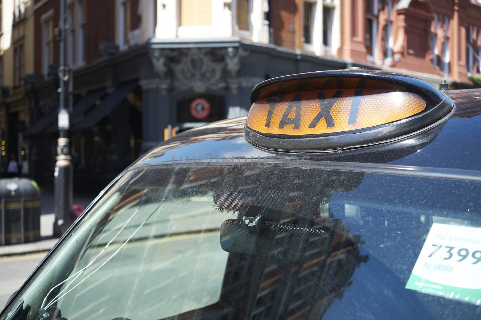 LONDON, UK - MAY 13: Detail famous black cab in street on sunny day. May 13, 2015 in London.