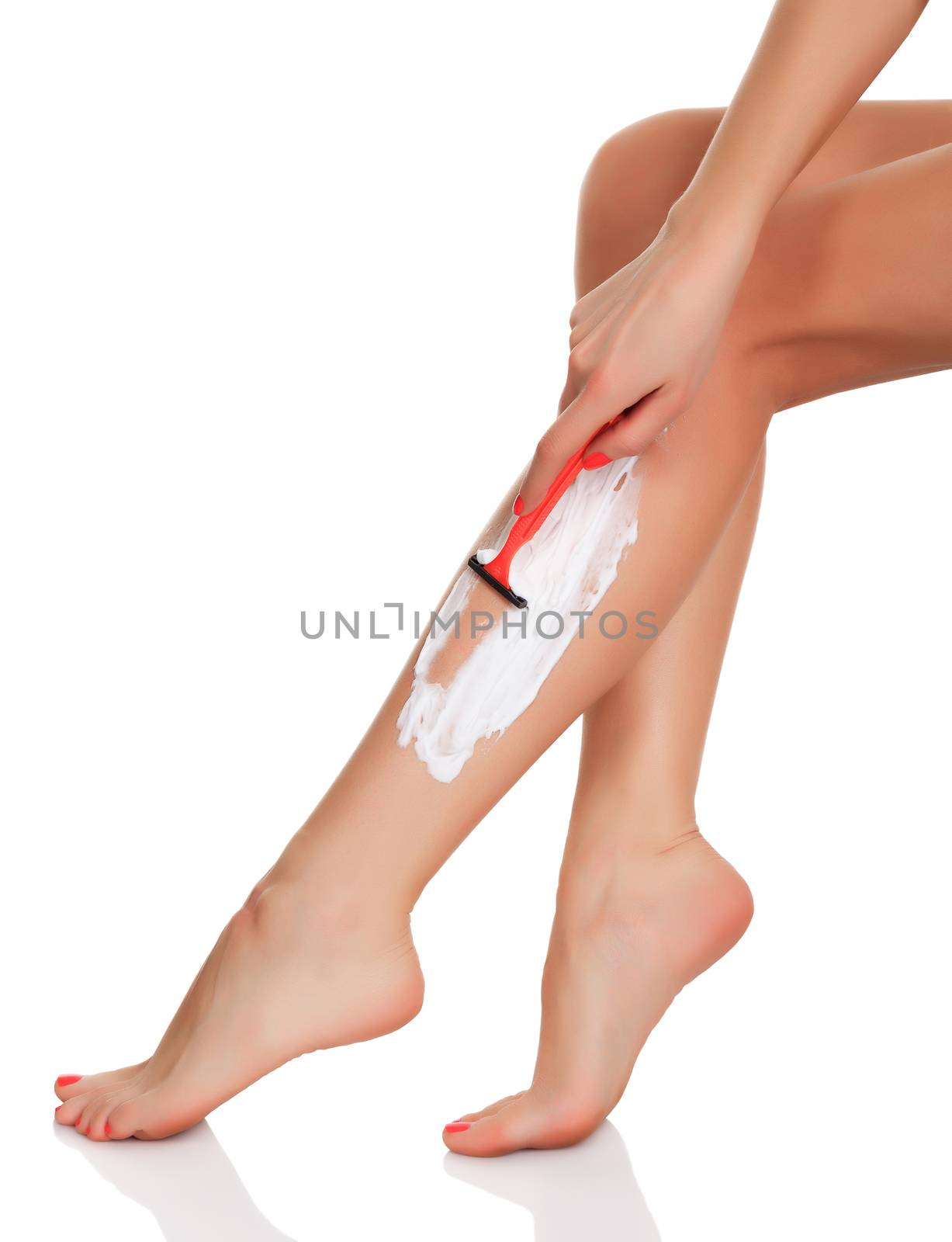 woman shaves her legs, isolated on white, copyspace