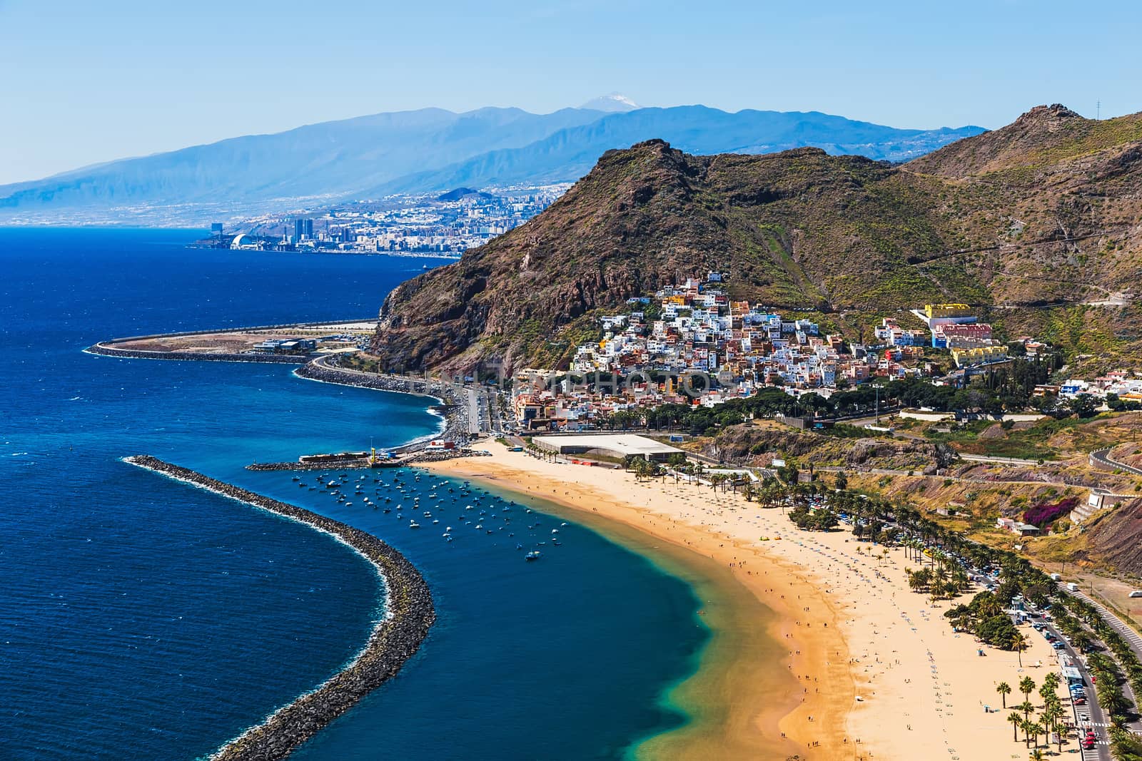 Aerial view to coast or shore of Atlantic ocean and beach Las Teresitas in Santa Cruz city on Tenerife Canary island, Spain at spring or summer. Teide volcano at background