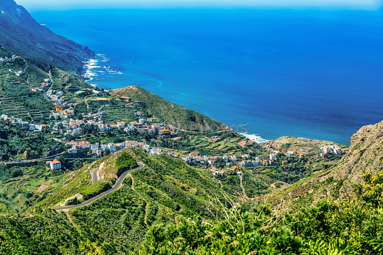 Mountain and clouds with small city or village landscape near the coast or shore of Atlantic ocean in Tenerife Canary island, Spain